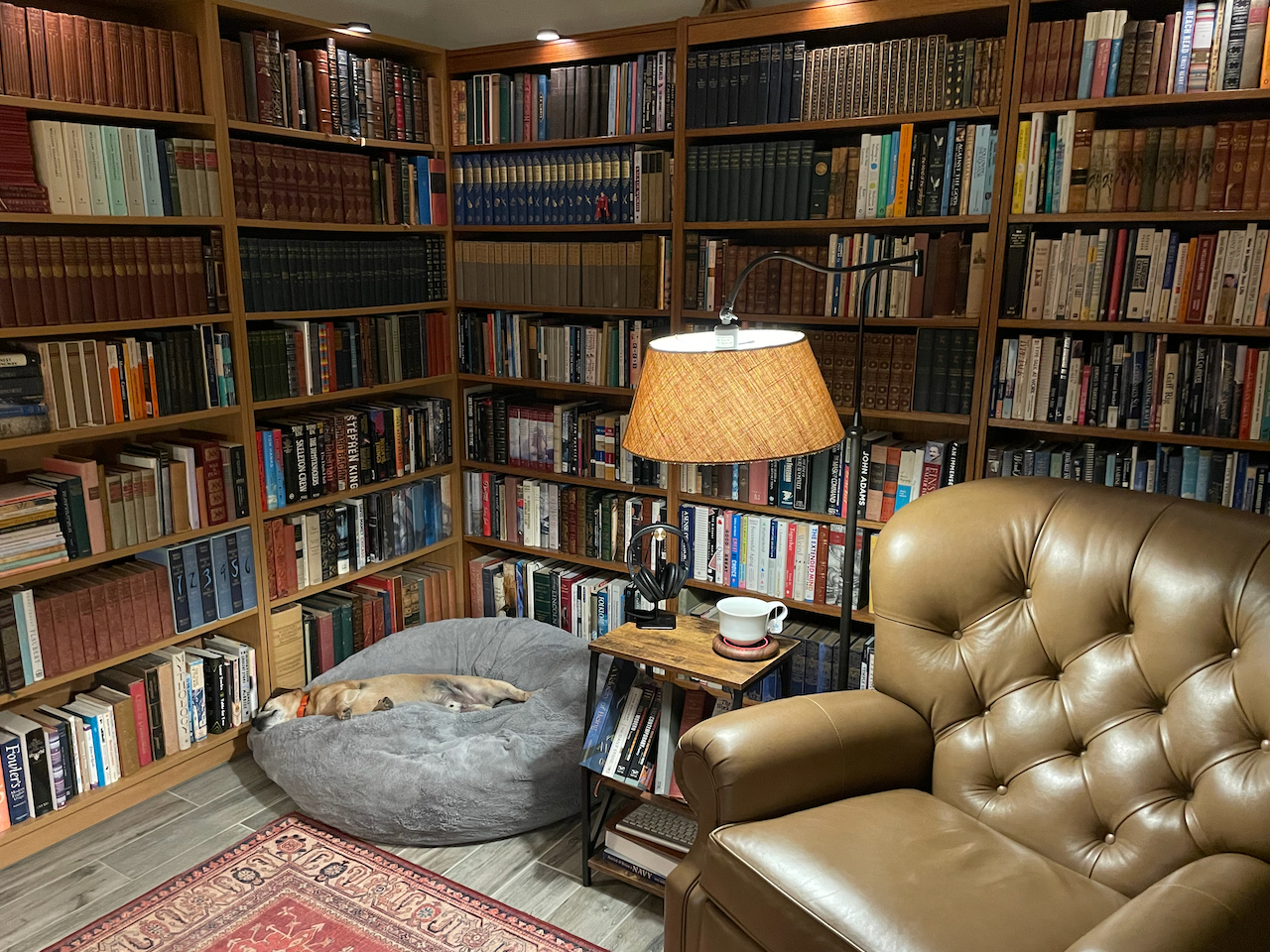 Home library with reading chair and sleeping dog